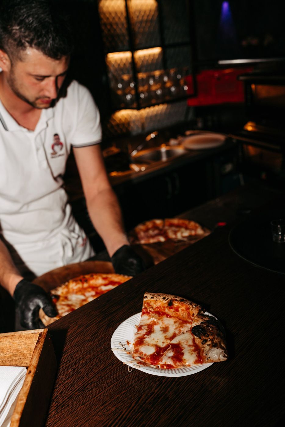 Kevo schneidet eine frisch gebackene Pizza an
